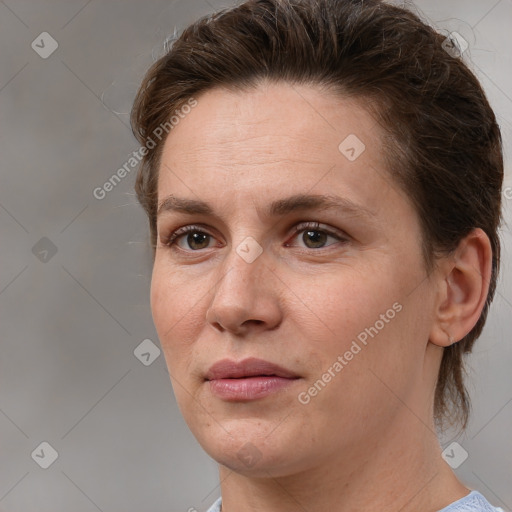 Joyful white adult female with medium  brown hair and grey eyes