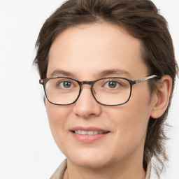 Joyful white young-adult female with medium  brown hair and grey eyes