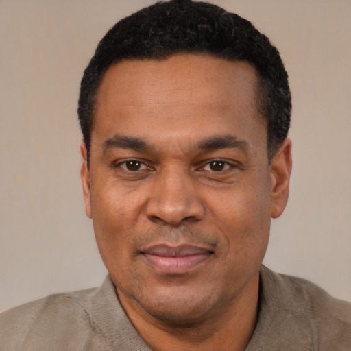 Joyful latino adult male with short  black hair and brown eyes