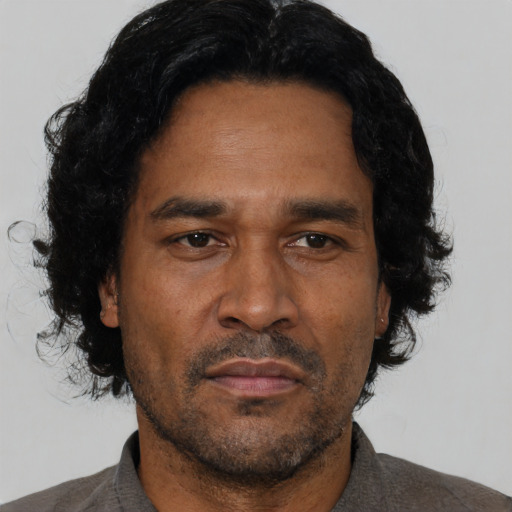 Neutral latino adult male with short  black hair and brown eyes