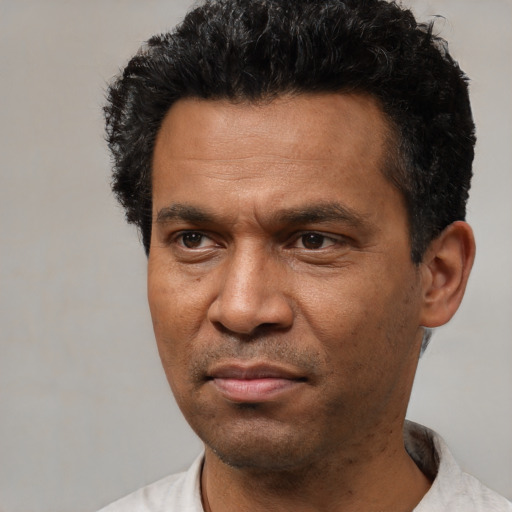 Neutral latino adult male with short  black hair and brown eyes