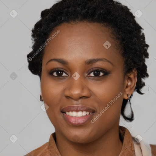 Joyful black young-adult female with long  black hair and brown eyes