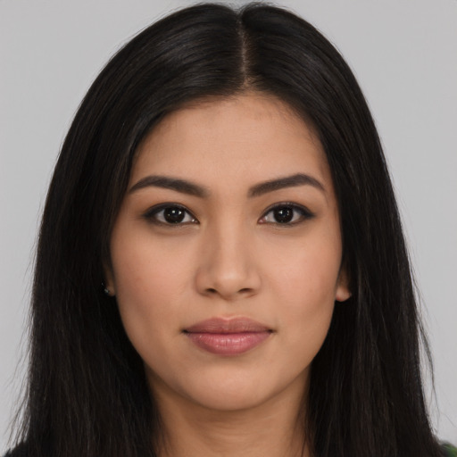 Joyful asian young-adult female with long  black hair and brown eyes