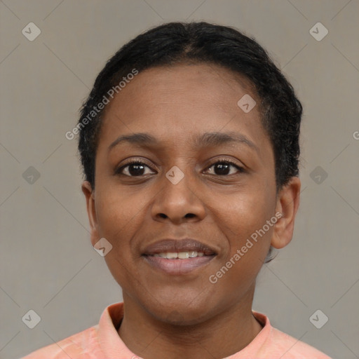 Joyful black young-adult female with short  black hair and brown eyes