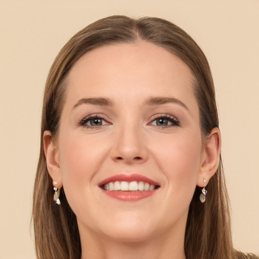 Joyful white young-adult female with long  brown hair and grey eyes