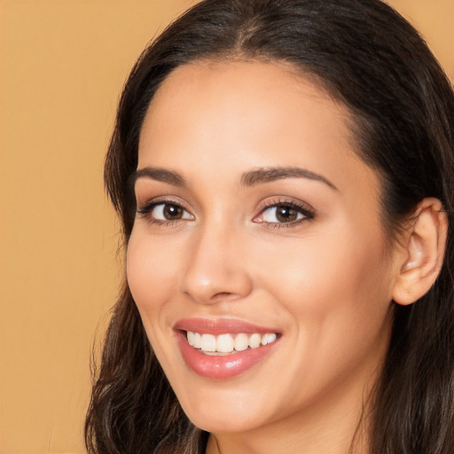 Joyful white young-adult female with long  brown hair and brown eyes