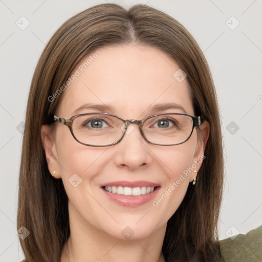 Joyful white adult female with long  brown hair and blue eyes