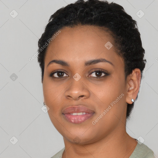 Joyful black young-adult female with short  black hair and brown eyes