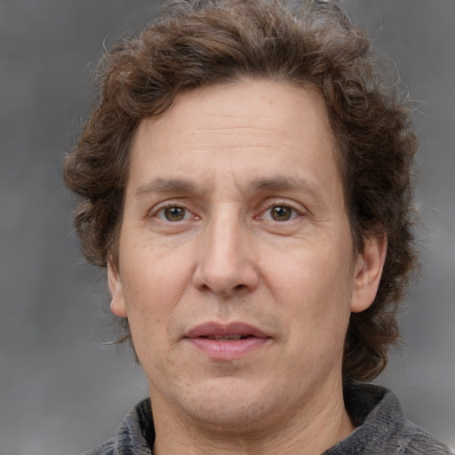 Joyful white adult male with medium  brown hair and grey eyes