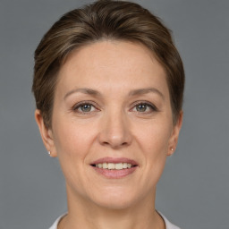 Joyful white adult female with short  brown hair and brown eyes