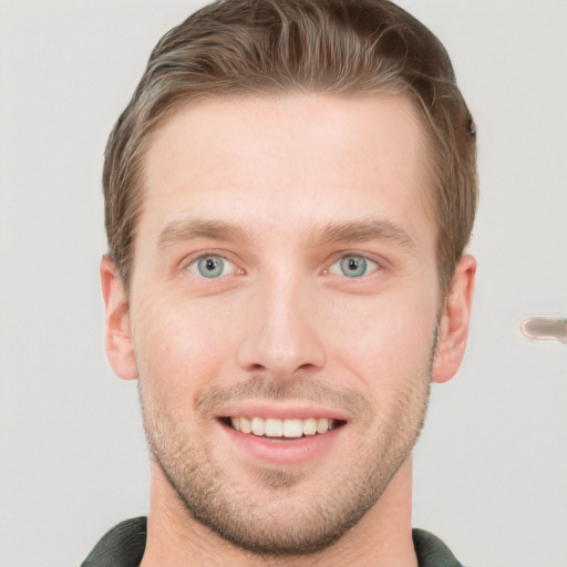 Joyful white young-adult male with short  brown hair and grey eyes