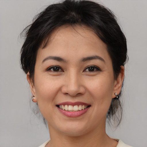 Joyful asian young-adult female with medium  brown hair and brown eyes