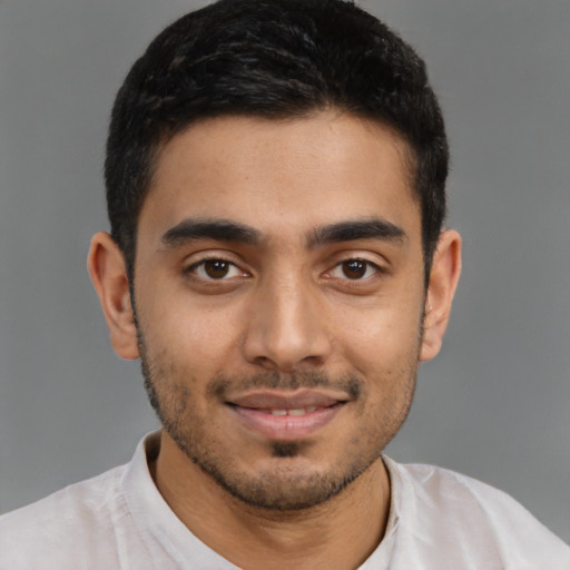 Joyful latino young-adult male with short  brown hair and brown eyes