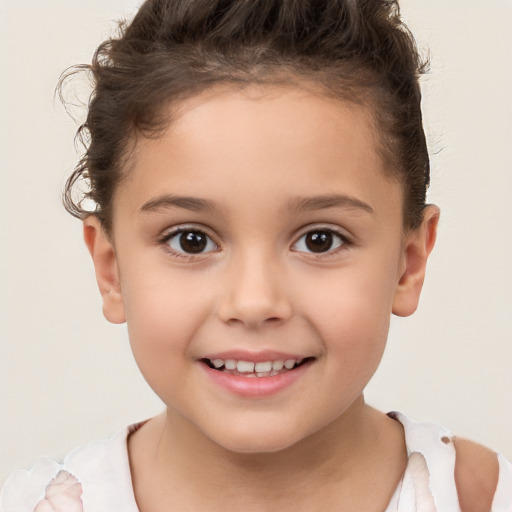 Joyful white child female with short  brown hair and brown eyes