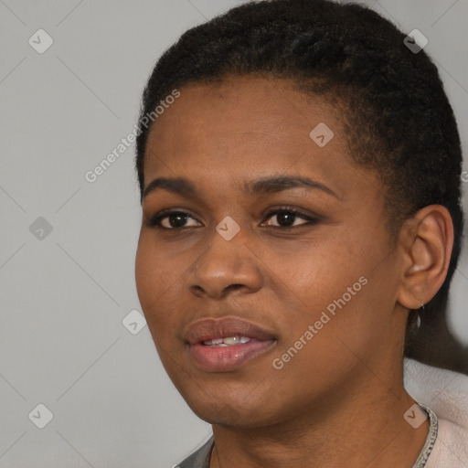 Joyful black young-adult female with short  black hair and brown eyes