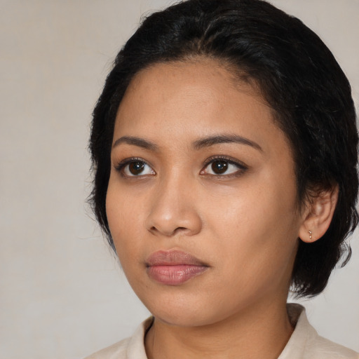 Neutral latino young-adult female with medium  black hair and brown eyes