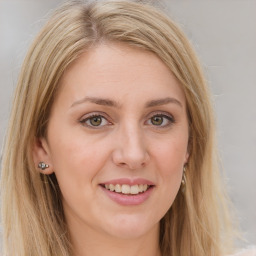 Joyful white young-adult female with long  brown hair and green eyes