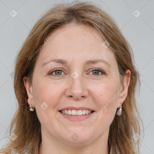 Joyful white adult female with long  brown hair and grey eyes