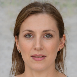 Joyful white young-adult female with medium  brown hair and grey eyes