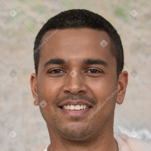 Joyful black young-adult male with short  black hair and brown eyes
