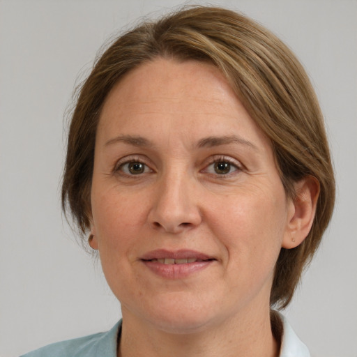 Joyful white adult female with medium  brown hair and grey eyes