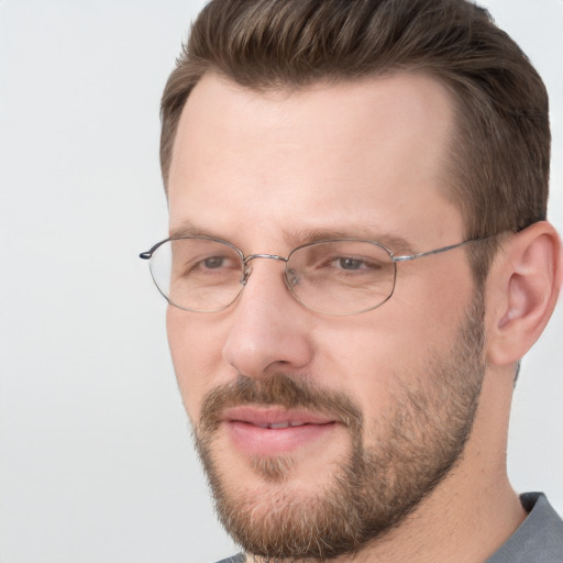 Joyful white adult male with short  brown hair and brown eyes