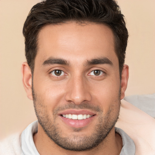 Joyful white young-adult male with short  brown hair and brown eyes