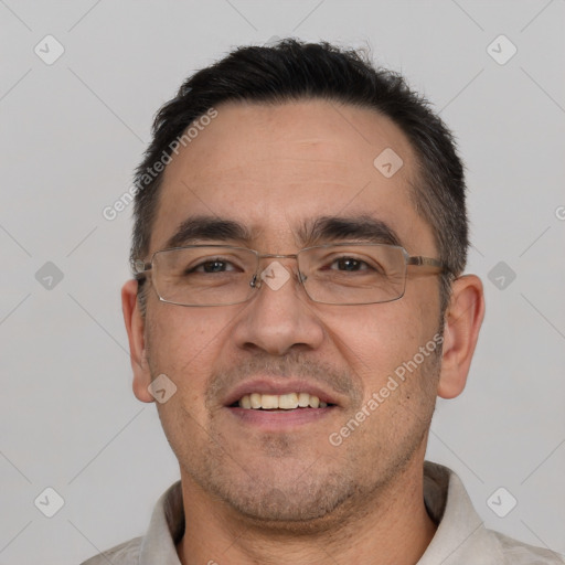 Joyful white adult male with short  black hair and brown eyes