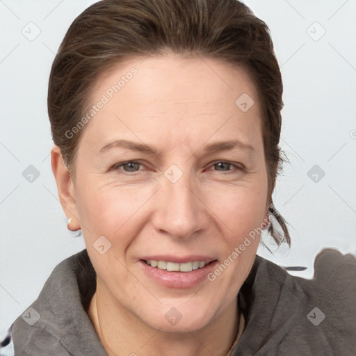 Joyful white adult female with medium  brown hair and grey eyes