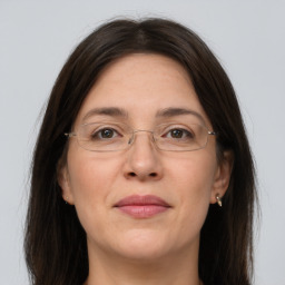 Joyful white adult female with long  brown hair and grey eyes