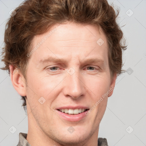 Joyful white adult male with short  brown hair and grey eyes