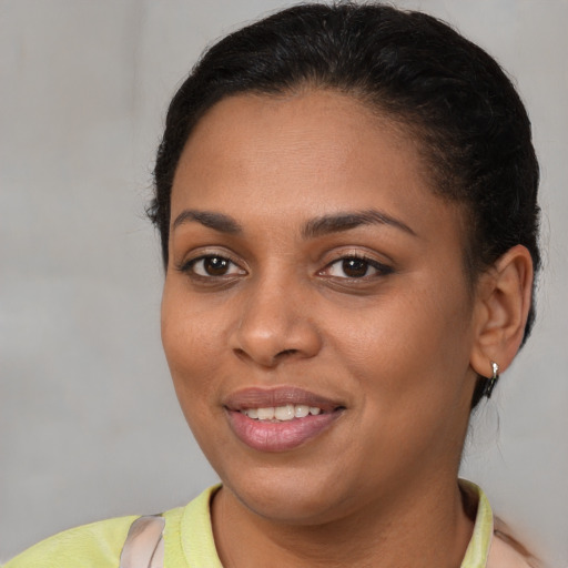 Joyful latino young-adult female with short  brown hair and brown eyes
