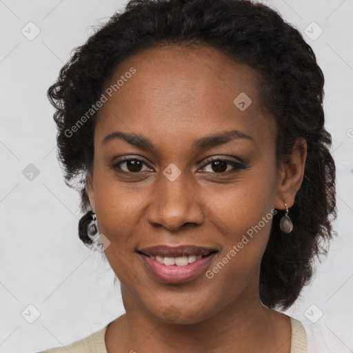 Joyful black young-adult female with long  brown hair and brown eyes