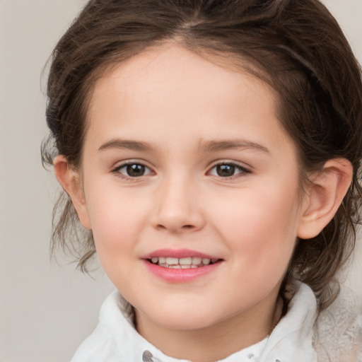 Joyful white child female with medium  brown hair and brown eyes