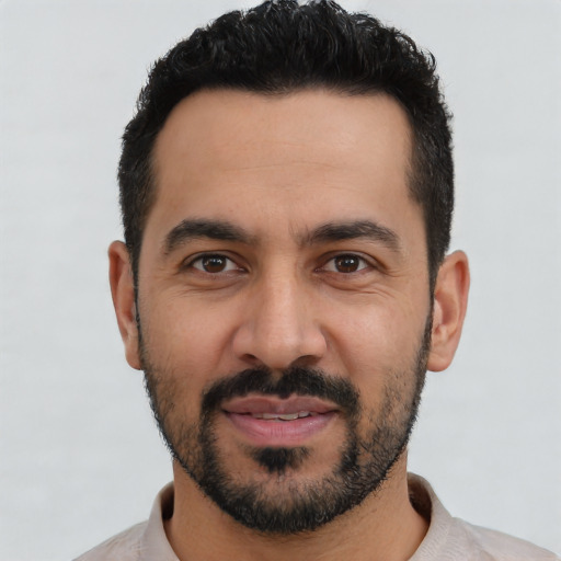 Joyful latino young-adult male with short  black hair and brown eyes