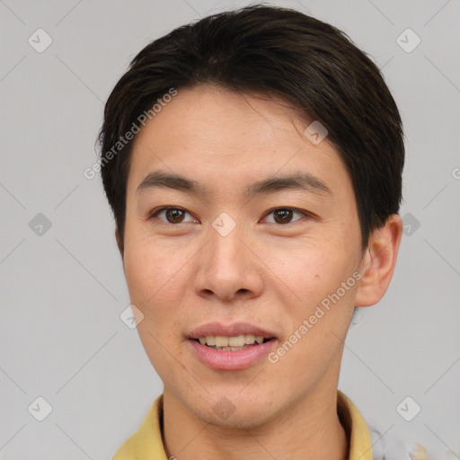 Joyful asian young-adult male with short  brown hair and brown eyes