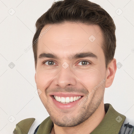 Joyful white young-adult male with short  brown hair and brown eyes