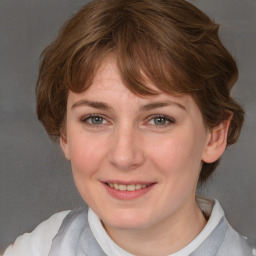 Joyful white young-adult female with medium  brown hair and blue eyes