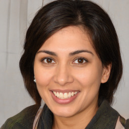 Joyful white young-adult female with medium  brown hair and brown eyes