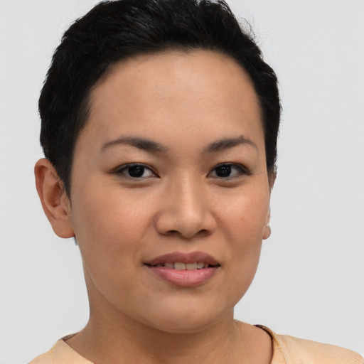 Joyful latino young-adult female with short  brown hair and brown eyes