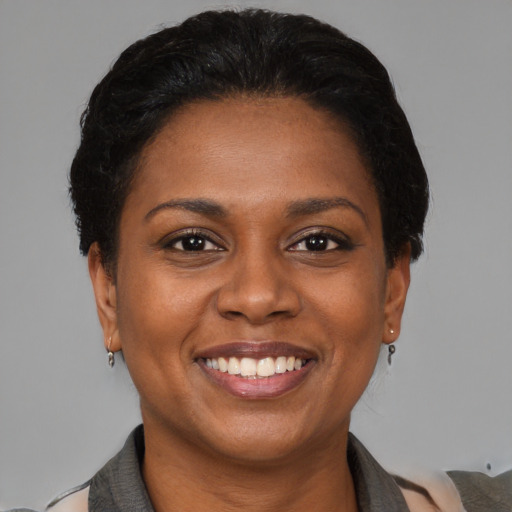 Joyful black young-adult female with medium  black hair and brown eyes