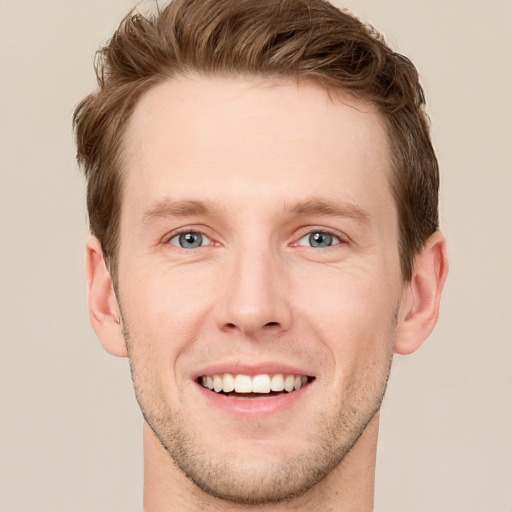 Joyful white young-adult male with short  brown hair and grey eyes