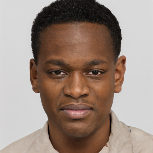 Joyful black young-adult male with short  brown hair and brown eyes