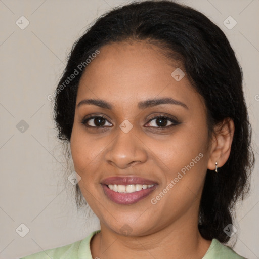 Joyful black young-adult female with long  black hair and brown eyes