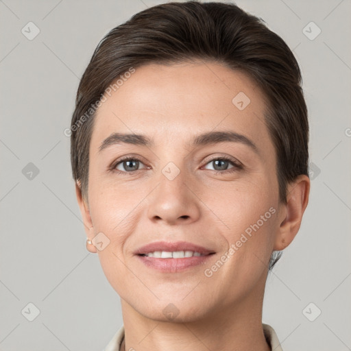 Joyful white young-adult female with short  brown hair and grey eyes