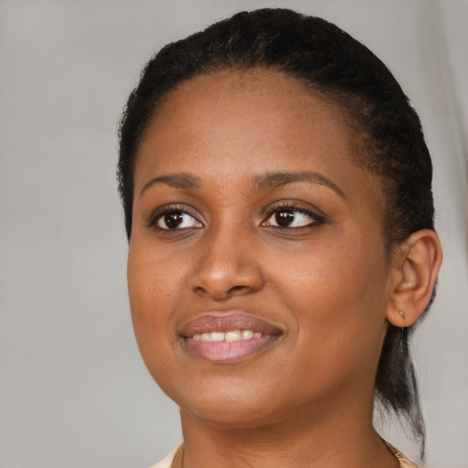 Joyful black young-adult female with medium  brown hair and brown eyes