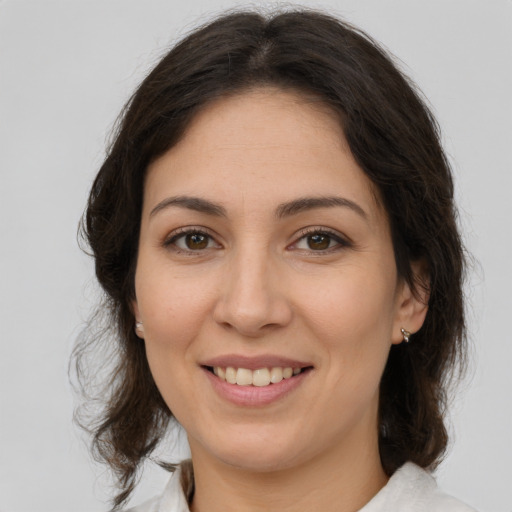 Joyful white young-adult female with medium  brown hair and brown eyes