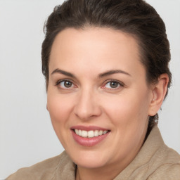 Joyful white young-adult female with medium  brown hair and brown eyes