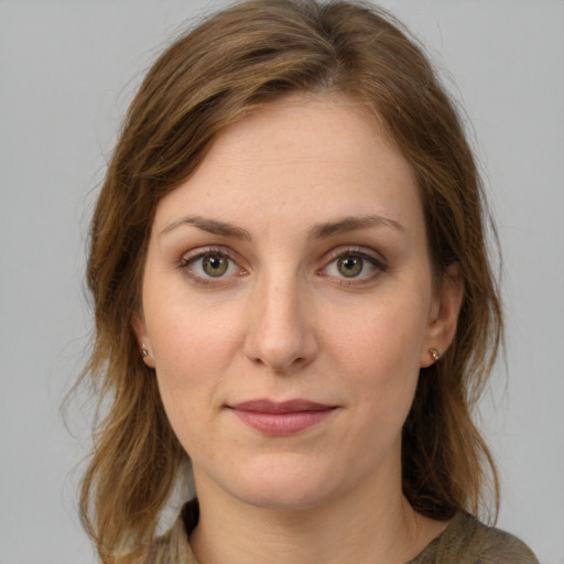 Joyful white young-adult female with medium  brown hair and green eyes