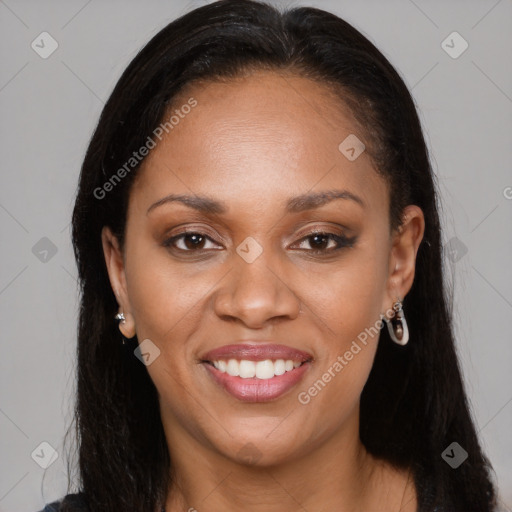 Joyful black young-adult female with long  brown hair and brown eyes